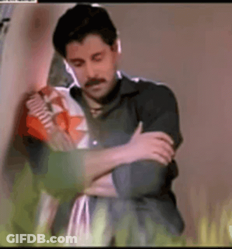 Woman Hugging Man With Arms Crossed GIF