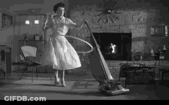 Woman Hula Hooping While Vacuum Cleaner Cleans Floor GIF