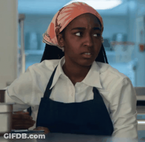 Woman In Apron And Head Scarf Looking GIF