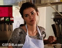Woman In Apron Before Machine With Letter A GIF
