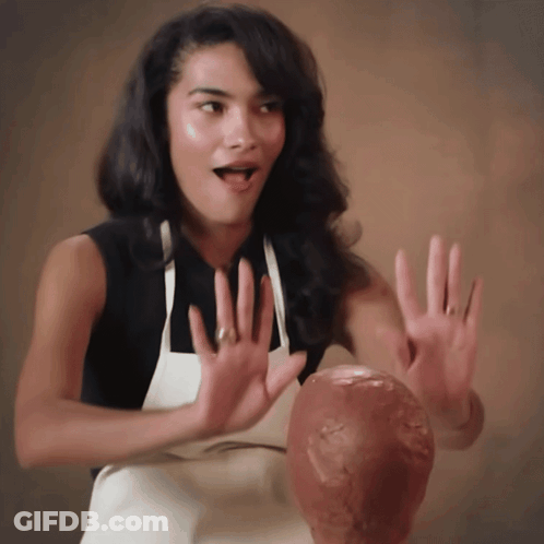Woman In Apron Holding Head Statue GIF
