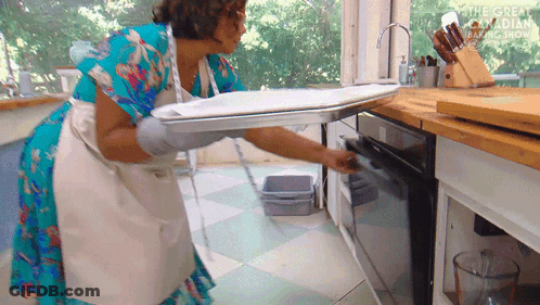 Woman In Apron Pulling Tray From Oven Great Canadian Baking Show GIF
