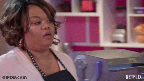Woman In Apron Standing Before Netflix Sign GIF