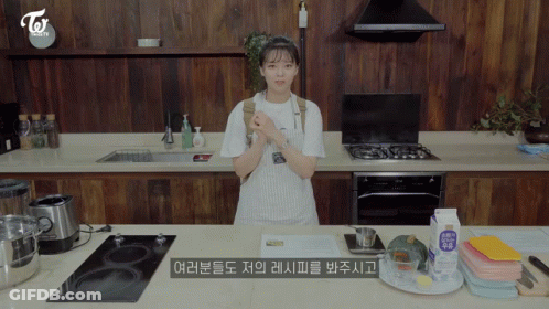 Woman In Apron Standing In Kitchen GIF