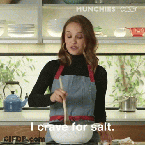 Woman In Apron Stirring Bowl Craving Salt GIF