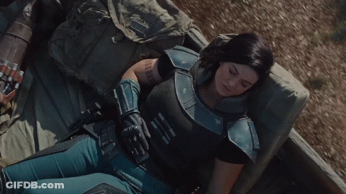 Woman In Armor Lying On Bed GIF