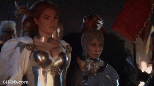 Woman In Armor Standing Next To Another Woman GIF