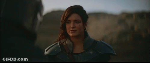 Woman In Armor Standing Next To Man In Helmet GIF