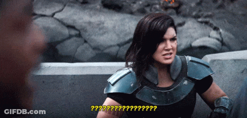 Woman In Armor Talking To Man With Question Mark GIF
