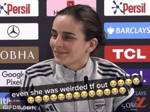 Woman In Arsenal Shirt Smiling In Front Of Persil And Barclays Ads GIF