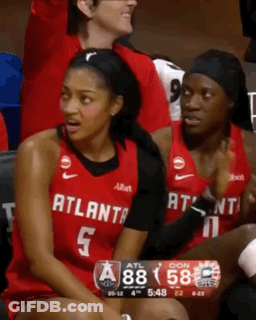 Woman In Atlanta Jersey Sits On Bench GIF