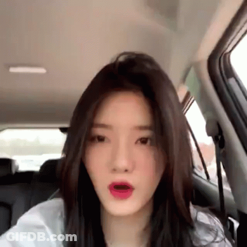Woman In Back Seat Of Car Making Funny Face GIF