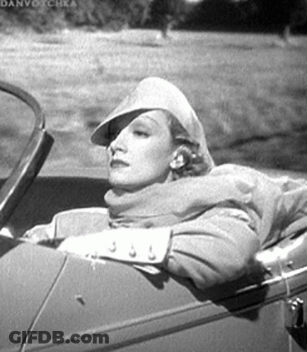 Woman In Back Seat With Hat And Scarf GIF