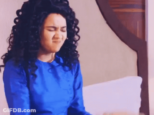 Woman In Bandana And Purse Standing In Bedroom GIF
