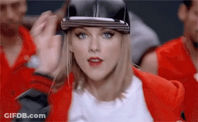 Woman In Baseball Cap, Red Jacket With Group GIF