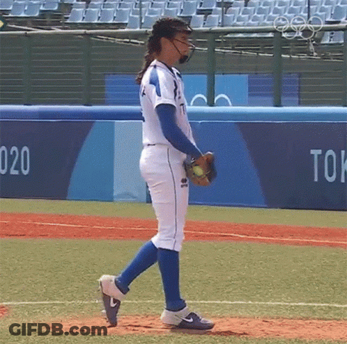 Woman In Baseball Uniform Walking On Field GIF