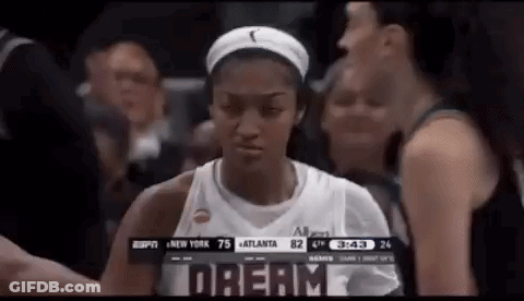 Woman In Basketball Uniform In Front Of Crowd GIF