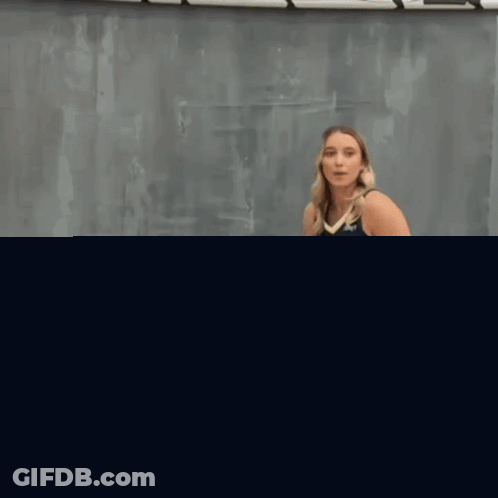 Woman In Basketball Uniform Kicking Ball GIF