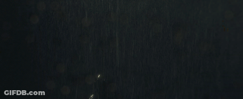 Woman In Bat Suit Standing In Rain GIF