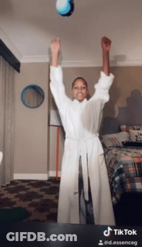 Woman In Bathrobe Arms In Air TikTok Watermark GIF