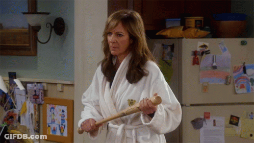 Woman In Bathrobe Holding Baseball Bat GIF