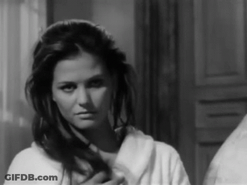 Woman In Bathrobe Looking In Mirror GIF