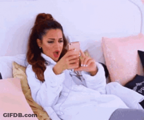 Woman In Bathrobe Lying On Bed GIF