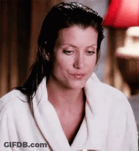 Woman In Bathrobe Making Funny Face With Wine GIF