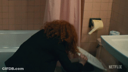 Woman In Bathroom With Netflix Logo GIF