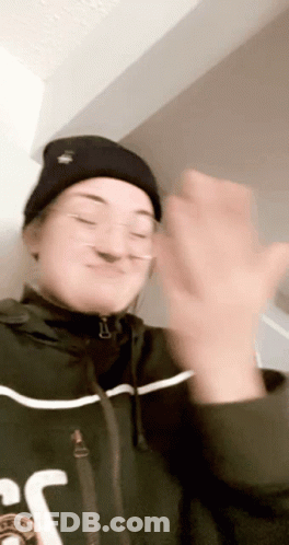Woman In Beanie And Glasses Clapping GIF