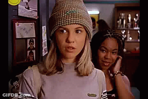Woman In Beanie And Striped Shirt Beside Another Woman GIF