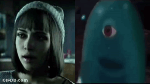 Woman In Beanie Talking To Blue Ghost With Red Eye GIF