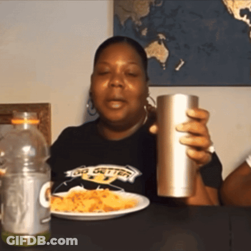 Woman In Big Getter Shirt Holding Cup And Plate GIF