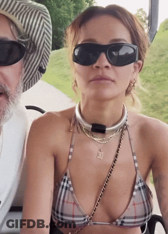 Woman In Bikini And Sunglasses Sitting Next To Man GIF