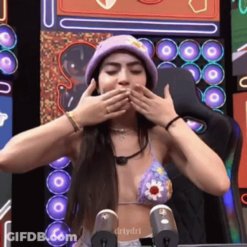 Woman In Bikini Covering Mouth With Purple Hat GIF