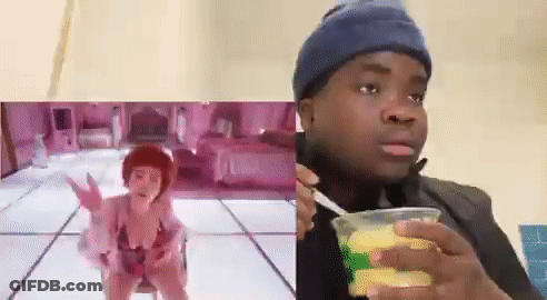 Woman In Bikini Dancing Next To Man With Corn Cup GIF