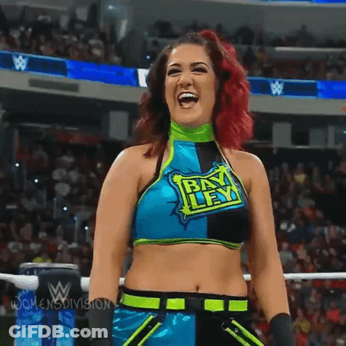Woman In Bikini Holding Bayley In The Bank Sign GIF