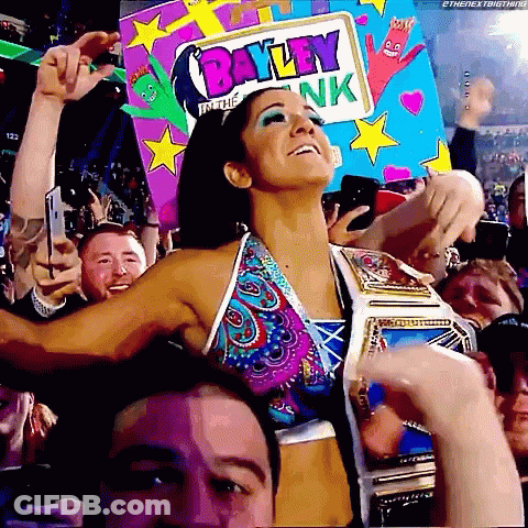 Woman In Bikini Holding Bayley In The Bank Sign GIF