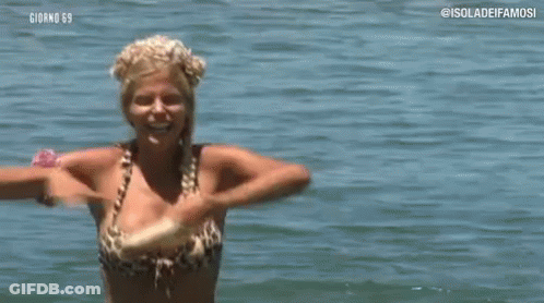Woman In Bikini Holding Stick In Water GIF