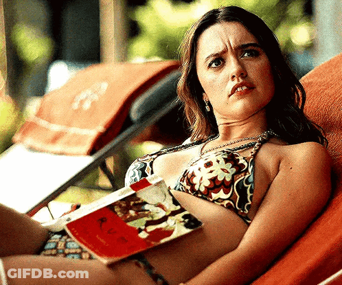 Woman In Bikini Laying On Lounge Chair Reading Book GIF