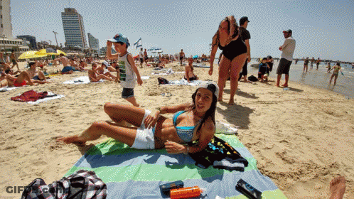 Woman In Bikini Lying On Beach Towel GIF