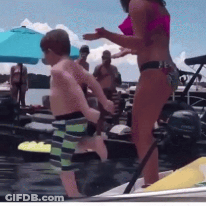 Woman In Bikini Next To Boy On Boat GIF