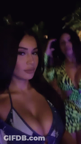 Woman In Bikini Next To Woman In Green Dress GIF