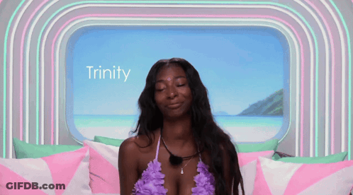 Woman In Bikini Sitting By Window With Trinity GIF