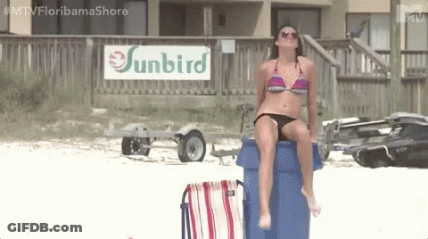 Woman In Bikini Sitting On Trash Can At Beach With Sunbird Sign GIF
