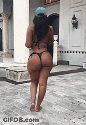 Woman In Bikini Walking On Brick Sidewalk GIF