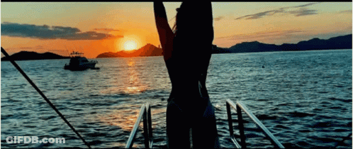 Woman In Bikini Watching Sunset On Boat GIF