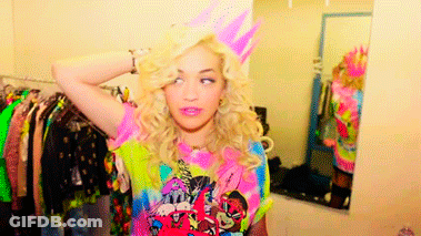 Woman In Birthday Hat In Front Of Dressing Room Mirror GIF