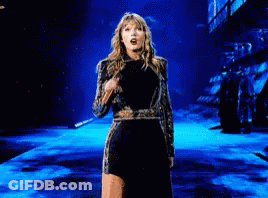 Woman In Black And Gold Dress Dancing On Stage GIF