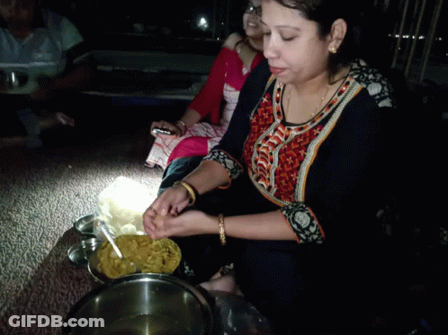Woman In Black And Orange Shirt Cooking In Bowl GIF